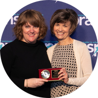Jill Filer (right), recipient of the NSPRA 2022 Barry Gaskins Mentor Legacy award, accepting her award from NSPRA 202-22 President Nicole Kirby, APR (left) at the NSPRA 2022 Seminar in Chicago.
